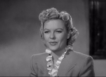 Movie still from “Ministry of Fear” (1944), directed by Fritz Lang – An old black and white photo of a woman in a suit; Close Up shot, High angle