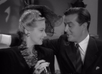 Movie still from “Ministry of Fear” (1944), directed by Fritz Lang – A man and a woman are smiling at each other; Close Up shot, High angle