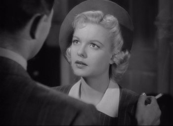 Movie still from “Ministry of Fear” (1944), directed by Fritz Lang – A woman in a hat looking at a man in a suit and tie; Close Up shot, Over the shoulder angle