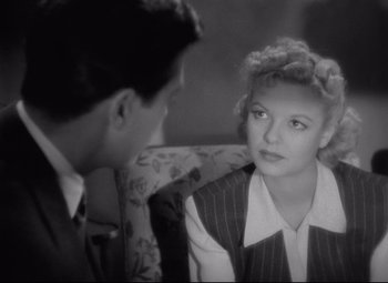 Movie still from “Ministry of Fear” (1944), directed by Fritz Lang – A man and a woman sitting on a couch talking to each other; Close Up shot, High angle