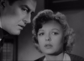 Movie still from “Ministry of Fear” (1944), directed by Fritz Lang – A man and a woman looking at each other in a black and white photo; Close Up shot, Low angle