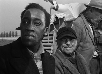 Movie still from “Miracle in Milan” (1951), directed by Vittorio De Sica – A black and white photo of two men; Close Up shot, Over the shoulder angle