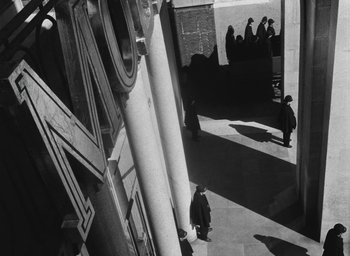 Movie still from “Miracle in Milan” (1951), directed by Vittorio De Sica – A black and white photo of people walking on a sidewalk; Extreme Wide shot, High angle