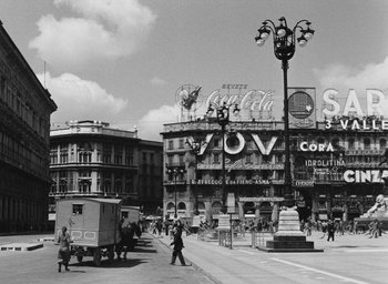 Movie still from “Miracle in Milan” (1951), directed by Vittorio De Sica – An old photo of a city street with many buildings; Extreme Wide shot, Low angle