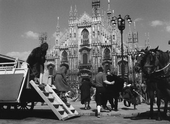 Movie still from “Miracle in Milan” (1951), directed by Vittorio De Sica – A black and white photo of people in front of a building; Extreme Wide shot, High angle