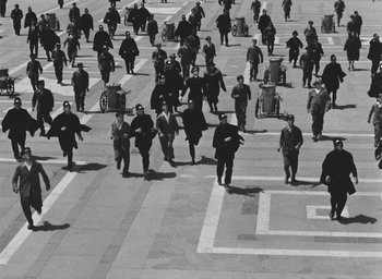 Movie still from “Miracle in Milan” (1951), directed by Vittorio De Sica – A black and white photo of a group of people walking down a street; Extreme Wide shot, High angle