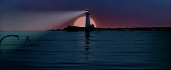 Movie still from “Miss Congeniality 2: Armed & Fabulous” (2005), directed by John Pasquin – A light house on a rock in the middle of the ocean at sunset; Extreme Wide shot, Low angle