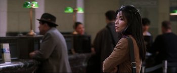 Movie still from “Miss Congeniality 2: Armed & Fabulous” (2005), directed by John Pasquin – A woman standing next to a group of other people; Close Up shot, Over the shoulder angle