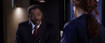 Movie still from “Miss Congeniality 2: Armed & Fabulous” (2005), directed by John Pasquin – A man wearing a suit and tie talking to another man wearing a suit and tie; Close Up shot, Over the shoulder angle