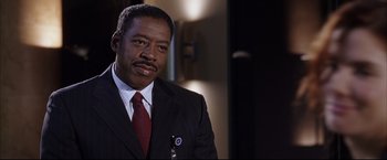 Movie still from “Miss Congeniality 2: Armed & Fabulous” (2005), directed by John Pasquin – A man in a suit and a tie; Close Up shot, Low angle