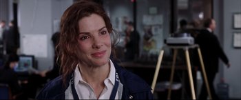 Movie still from “Miss Congeniality 2: Armed & Fabulous” (2005), directed by John Pasquin – A person smiling for a picture; Close Up shot, Over the shoulder angle