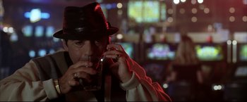 Movie still from “Miss Congeniality 2: Armed & Fabulous” (2005), directed by John Pasquin – A man in a fedora drinking a beverage; Close Up shot, Low angle