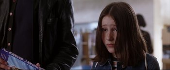 Movie still from “Miss Congeniality 2: Armed & Fabulous” (2005), directed by John Pasquin – A young girl looking sad while standing next to a man; Close Up shot, Over the shoulder angle