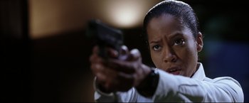 Movie still from “Miss Congeniality 2: Armed & Fabulous” (2005), directed by John Pasquin – A woman holding a gun in her hand; Close Up shot, Low angle