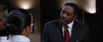 Movie still from “Miss Congeniality 2: Armed & Fabulous” (2005), directed by John Pasquin – A man wearing a suit and tie talking to a woman; Close Up shot, Over the shoulder angle