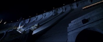 Movie still from “Miss Congeniality 2: Armed & Fabulous” (2005), directed by John Pasquin – A person riding a skate board down a ramp at night time; Extreme Wide shot, Low angle