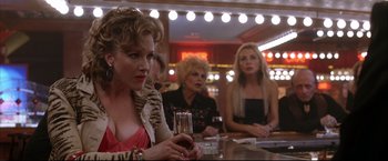 Movie still from “Miss Congeniality 2: Armed & Fabulous” (2005), directed by John Pasquin – A group of women sitting at a table with drinks; Medium shot, Over the shoulder angle