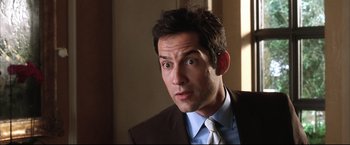 Movie still from “Miss Congeniality 2: Armed & Fabulous” (2005), directed by John Pasquin – A person wearing a suit and tie; Close Up shot, Over the shoulder angle
