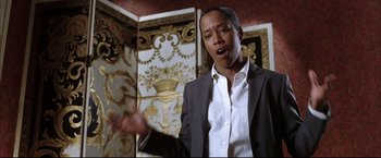 Movie still from “Miss Congeniality 2: Armed & Fabulous” (2005), directed by John Pasquin – A man in a white shirt and a suit; Close Up shot, Low angle