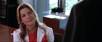 Movie still from “Miss Congeniality 2: Armed & Fabulous” (2005), directed by John Pasquin – A woman sitting in a chair in front of a window; Close Up shot, Over the shoulder angle