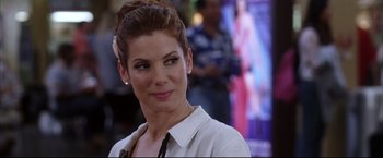 Movie still from “Miss Congeniality 2: Armed & Fabulous” (2005), directed by John Pasquin – A person wearing a white shirt; Close Up shot, Over the shoulder angle