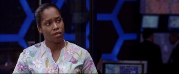 Movie still from “Miss Congeniality 2: Armed & Fabulous” (2005), directed by John Pasquin – A woman in a floral shirt is listening to music; Close Up shot, Over the shoulder angle