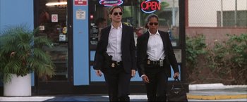 Movie still from “Miss Congeniality 2: Armed & Fabulous” (2005), directed by John Pasquin – A couple of women walking down a street; Medium shot, Low angle