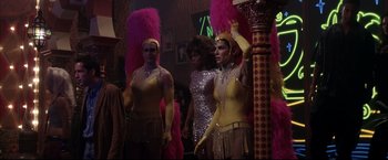 Movie still from “Miss Congeniality 2: Armed & Fabulous” (2005), directed by John Pasquin – A group of people dressed up in costumes and wigs; Medium shot, Low angle