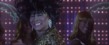 Movie still from “Miss Congeniality 2: Armed & Fabulous” (2005), directed by John Pasquin – A person wearing a dress; Close Up shot, Low angle