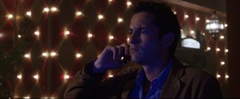 Movie still from “Miss Congeniality 2: Armed & Fabulous” (2005), directed by John Pasquin – A man is talking on a cell phone in the dark; Close Up shot, Low angle