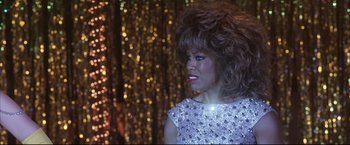 Movie still from “Miss Congeniality 2: Armed & Fabulous” (2005), directed by John Pasquin – A person wearing a dress; Close Up shot, Over the shoulder angle