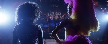 Movie still from “Miss Congeniality 2: Armed & Fabulous” (2005), directed by John Pasquin – Two women are standing next to each other in front of a crowd of onlookers; Medium shot, Low angle
