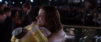 Movie still from “Miss Congeniality 2: Armed & Fabulous” (2005), directed by John Pasquin – A woman is hugging a man in a yellow shirt; Close Up shot, Over the shoulder angle