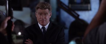 Movie still from “Miss Congeniality 2: Armed & Fabulous” (2005), directed by John Pasquin – A person wearing a suit and tie; Close Up shot, Over the shoulder angle