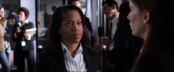 Movie still from “Miss Congeniality 2: Armed & Fabulous” (2005), directed by John Pasquin – A woman in a suit and tie; Close Up shot, Over the shoulder angle