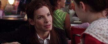 Movie still from “Miss Congeniality 2: Armed & Fabulous” (2005), directed by John Pasquin – A person sitting in front of another person; Close Up shot, Over the shoulder angle