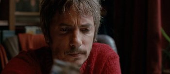 Movie still from “Mister Lonely” (2007), directed by Harmony Korine – A person wearing a red sweater; Close Up shot, Low angle