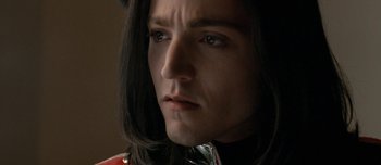 Movie still from “Mister Lonely” (2007), directed by Harmony Korine – A person with long black hair; Close Up shot, Low angle