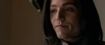 Movie still from “Mister Lonely” (2007), directed by Harmony Korine – A person with long black hair; Close Up shot, Low angle