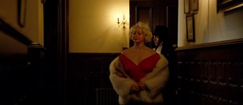 Movie still from “Mister Lonely” (2007), directed by Harmony Korine – A woman in a red dress and a man in a black suit; Medium shot, Low angle