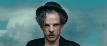 Movie still from “Mister Lonely” (2007), directed by Harmony Korine – A person wearing a hat; Close Up shot, Low angle