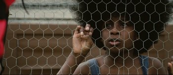 Movie still from “Mister Lonely” (2007), directed by Harmony Korine – A young woman holding her hand up to her face; Close Up shot, Low angle