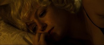 Movie still from “Mister Lonely” (2007), directed by Harmony Korine – A woman laying in bed with her head resting on her hand; Extreme Close Up shot, High angle