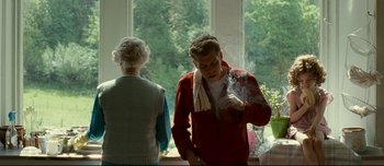 Movie still from “Mister Lonely” (2007), directed by Harmony Korine – A young man smoking a cigarette next to a woman; Medium shot, Over the shoulder angle