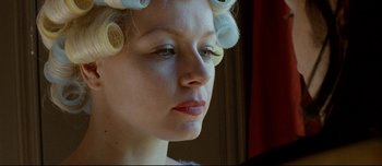 Movie still from “Mister Lonely” (2007), directed by Harmony Korine – A person wearing hair curlers on their head; Close Up shot, Low angle