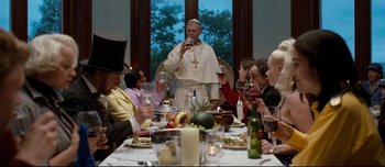 Movie still from “Mister Lonely” (2007), directed by Harmony Korine – A man standing in front of a group of people; Medium shot, Over the shoulder angle