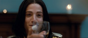 Movie still from “Mister Lonely” (2007), directed by Harmony Korine – A woman holding a wine glass in front of her face; Close Up shot, Low angle