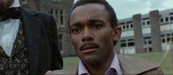 Movie still from “Mister Lonely” (2007), directed by Harmony Korine – A person wearing a suit and tie; Close Up shot, Low angle