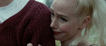Movie still from “Mister Lonely” (2007), directed by Harmony Korine – A person holding a sweater; Close Up shot, Over the shoulder angle