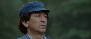 Movie still from “Mister Lonely” (2007), directed by Harmony Korine – A person wearing a hat; Close Up shot, Low angle